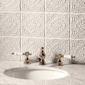 Waveney Highgrove polished chrome faucet with white ceramic handles against embossed white porcelain tiles