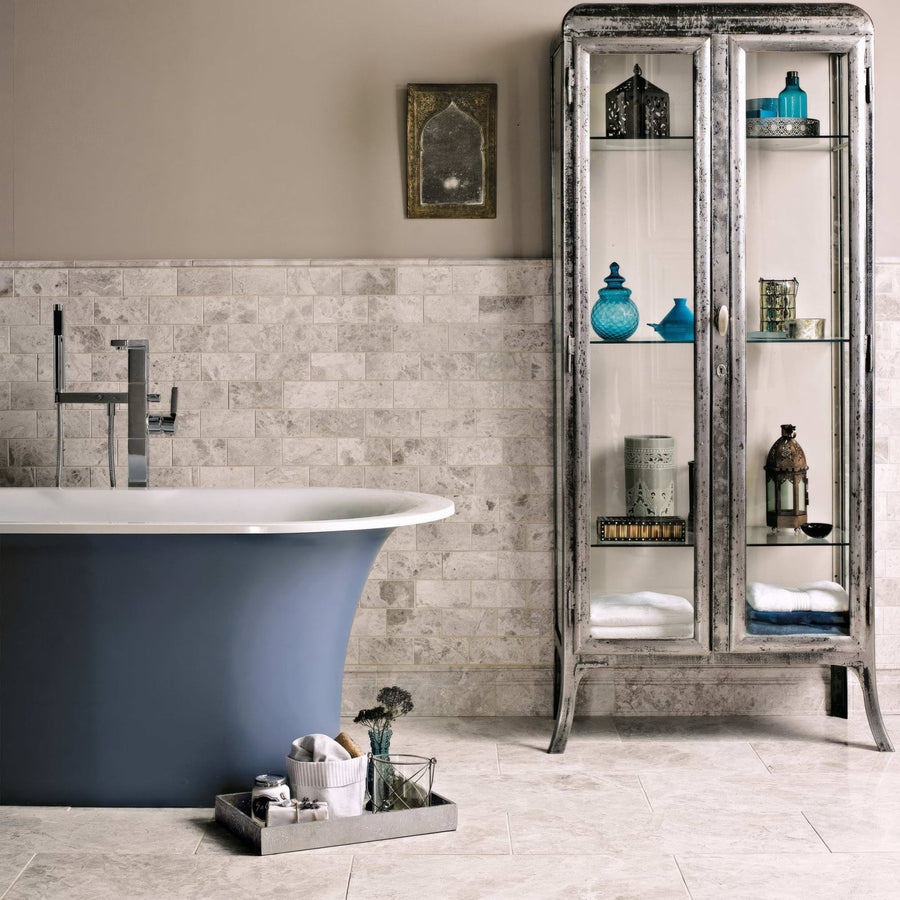 Westhampton Diamond Sawn Edge 7 x 14cm grey marble tiles with a blue freestanding bathtub