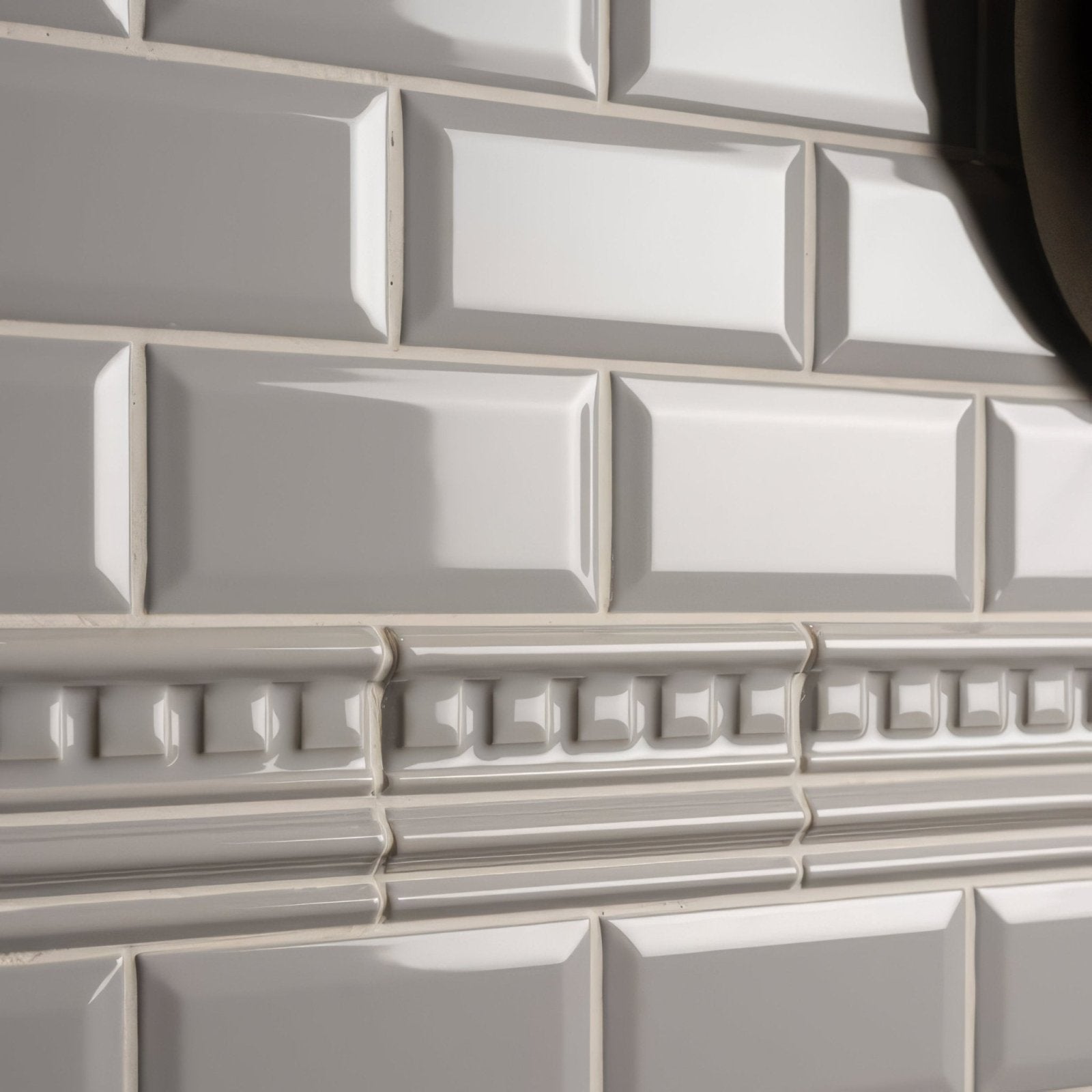 White glossy subway tiles with decorative gray dentil moulding border in westminster grey for wall accents