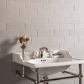White ceramic wall-mounted sink with chrome fixtures and towel rack in westminster grey large brick setting