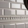 Westminster grey omega moulding gray glossy subway tile with raised edges arranged in a classic brick pattern