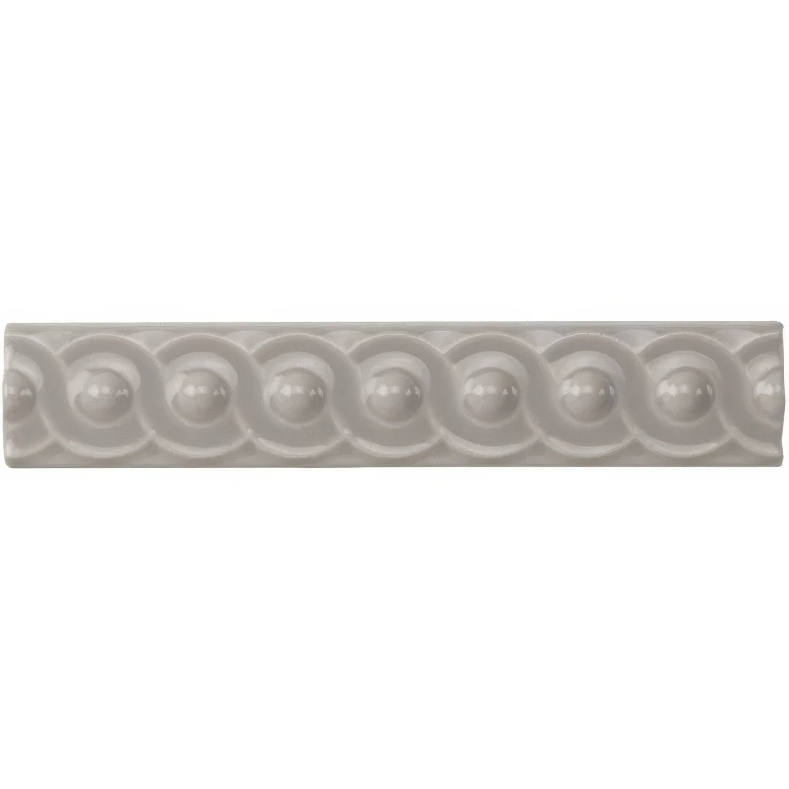 A sleek off-white ceramic tile with a repeating scalloped and beaded pattern from westminster grey scroll moulding