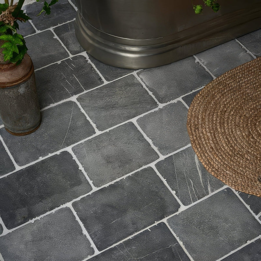 Dark gray rectangular wexford limestone cobble tumbled finish tiles with white grout lines for flooring and walls