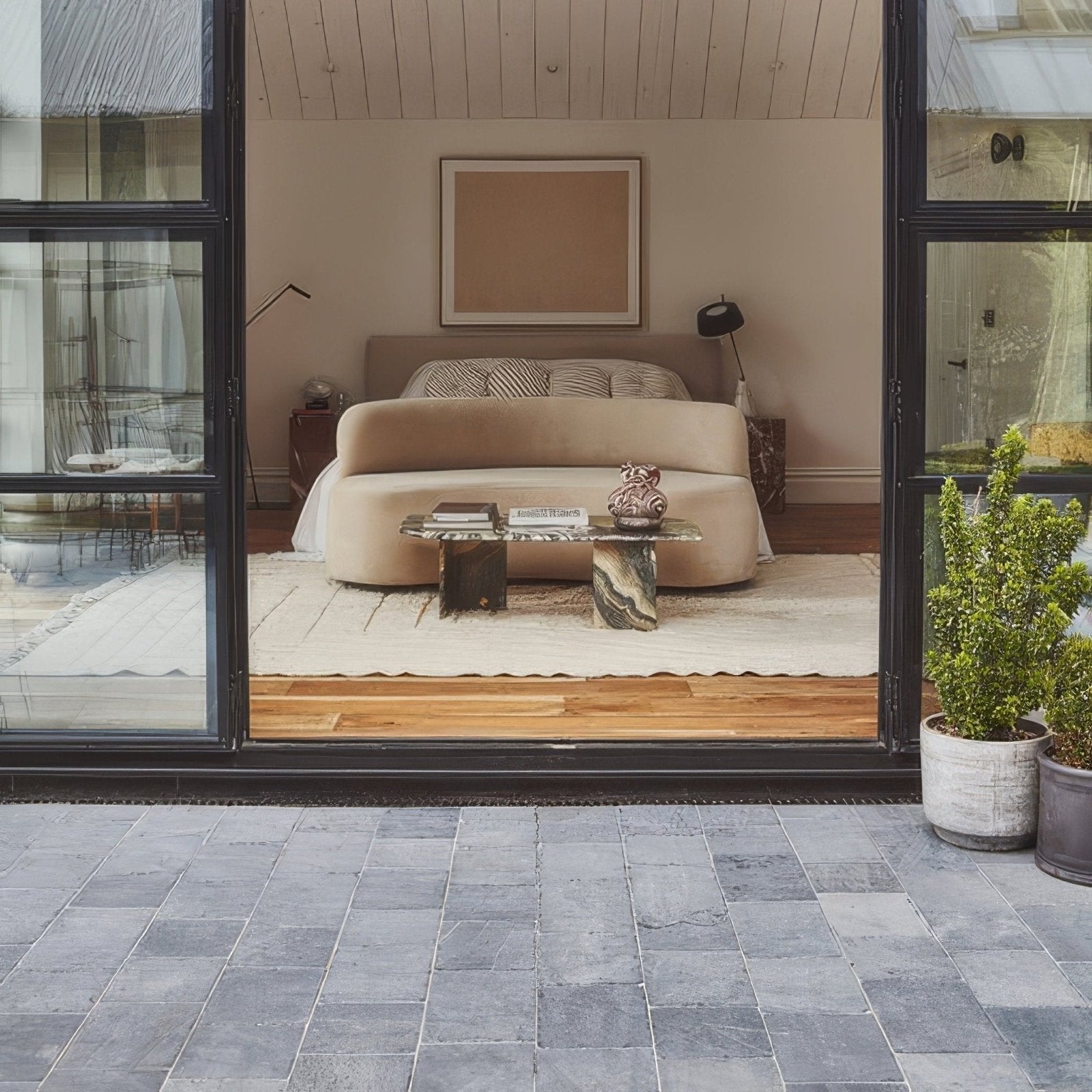 Beige upholstered bed with curved headboard and footboard in wexford limestone cobble tumbled finish