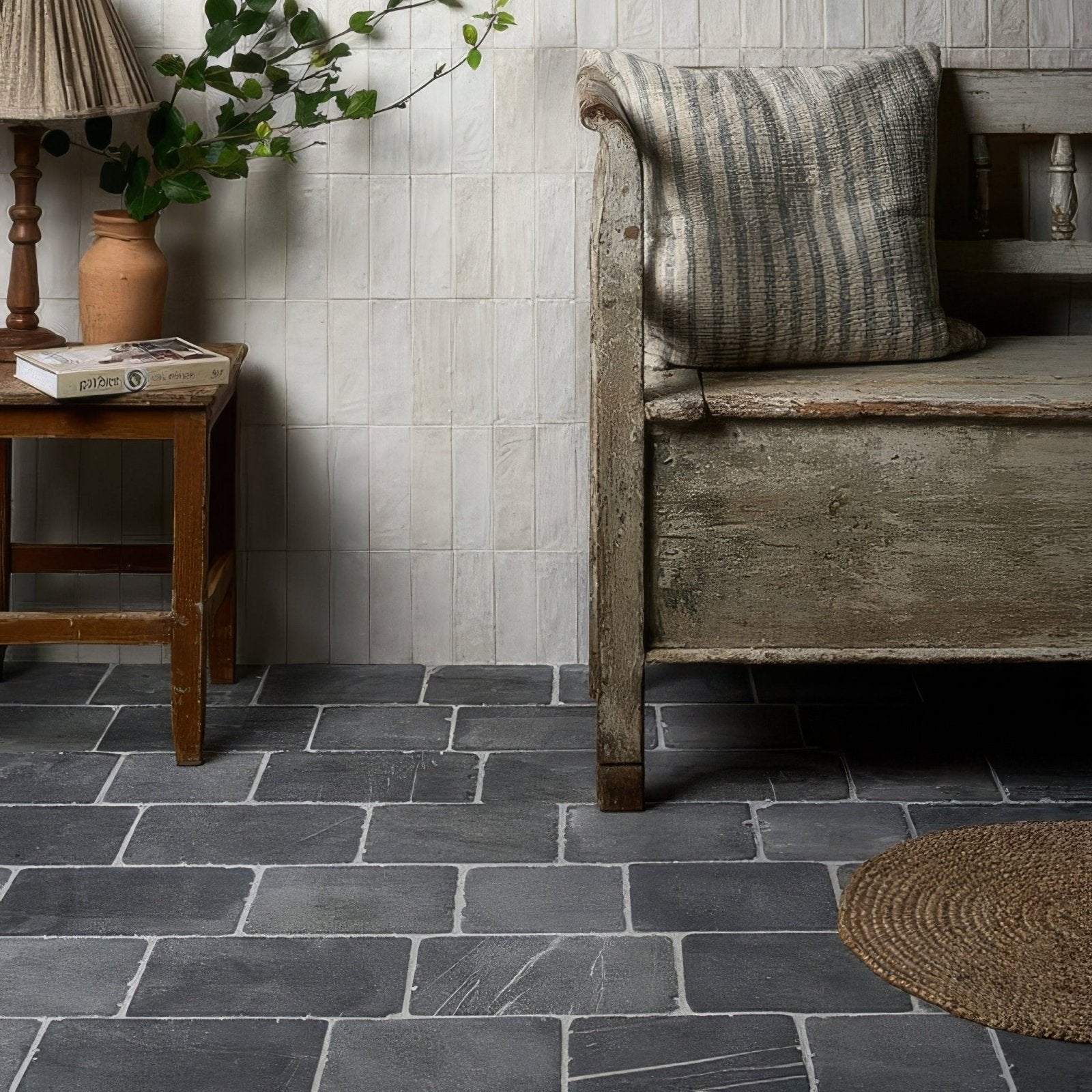 Gray stone tile floor with visible grout lines in wexford limestone cobble tumbled finish natural texture