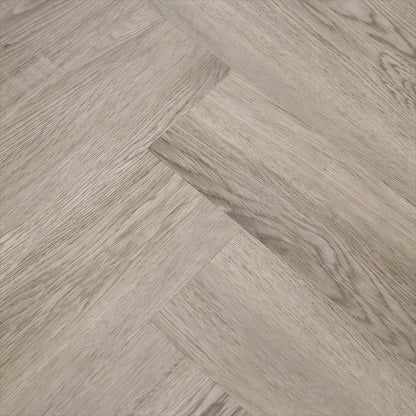 Grayish wood-effect Weymouth Alaskan Oak herringbone flooring planks with a textured oak pattern