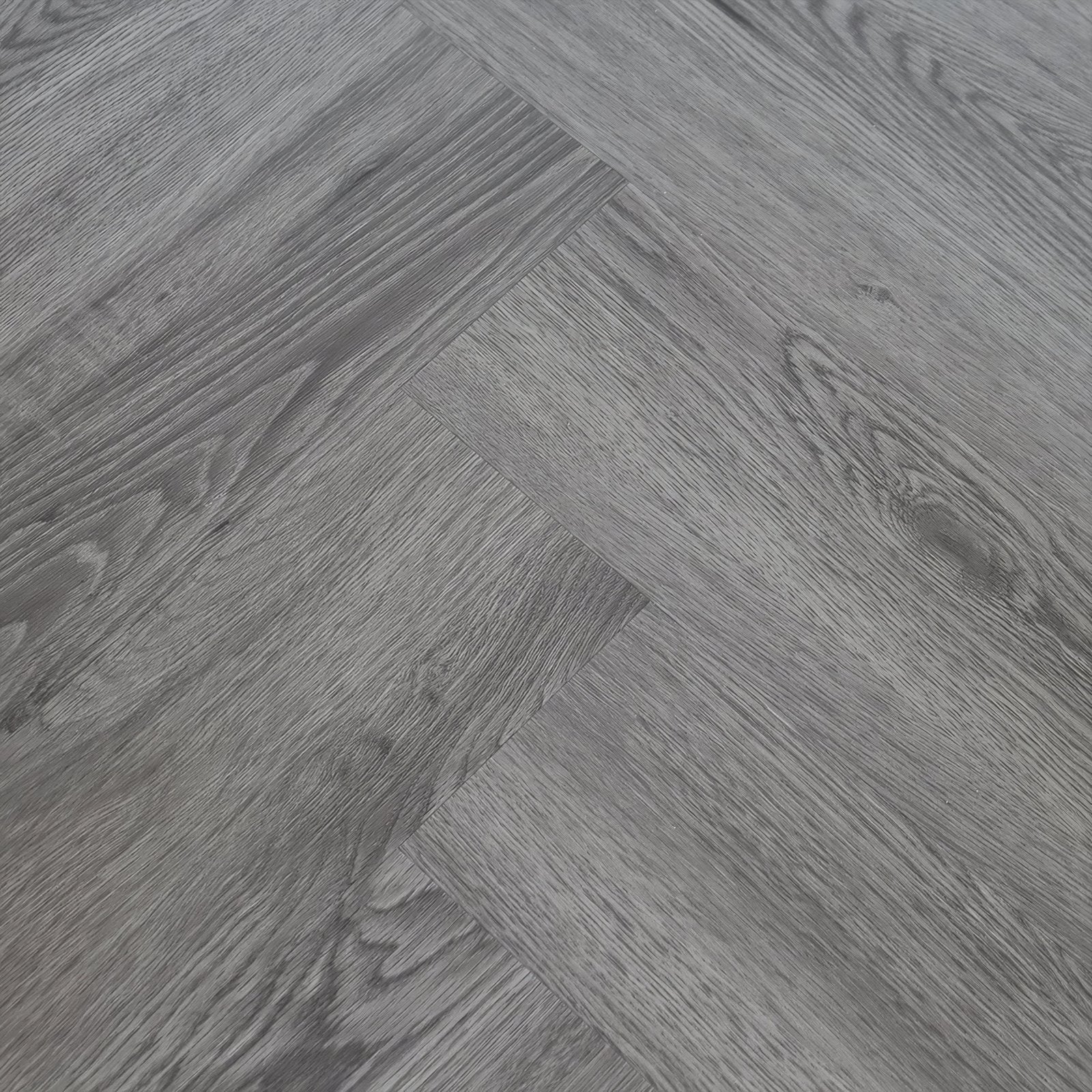 Gray herringbone-patterned hardwood flooring with subtle wood grain texture in weymouth echo oak herringbone style