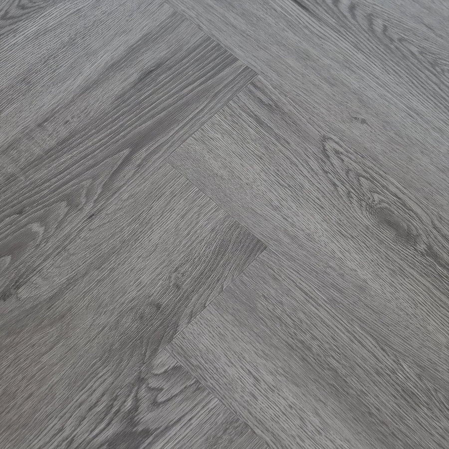 Gray herringbone-patterned hardwood flooring with subtle wood grain texture in weymouth echo oak herringbone style