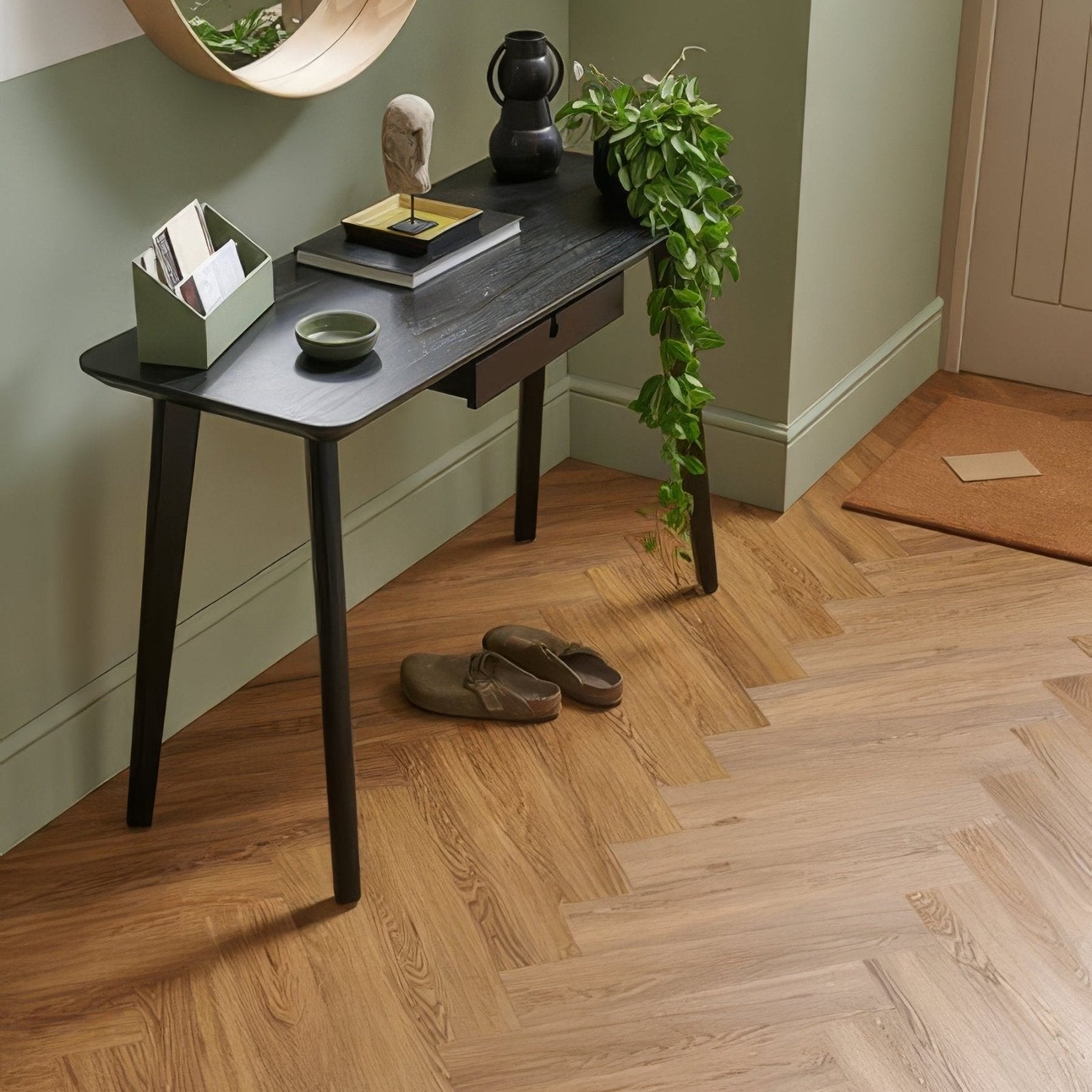Black wooden console table with slender legs and single drawer from weymouth millhouse oak herringbone collection