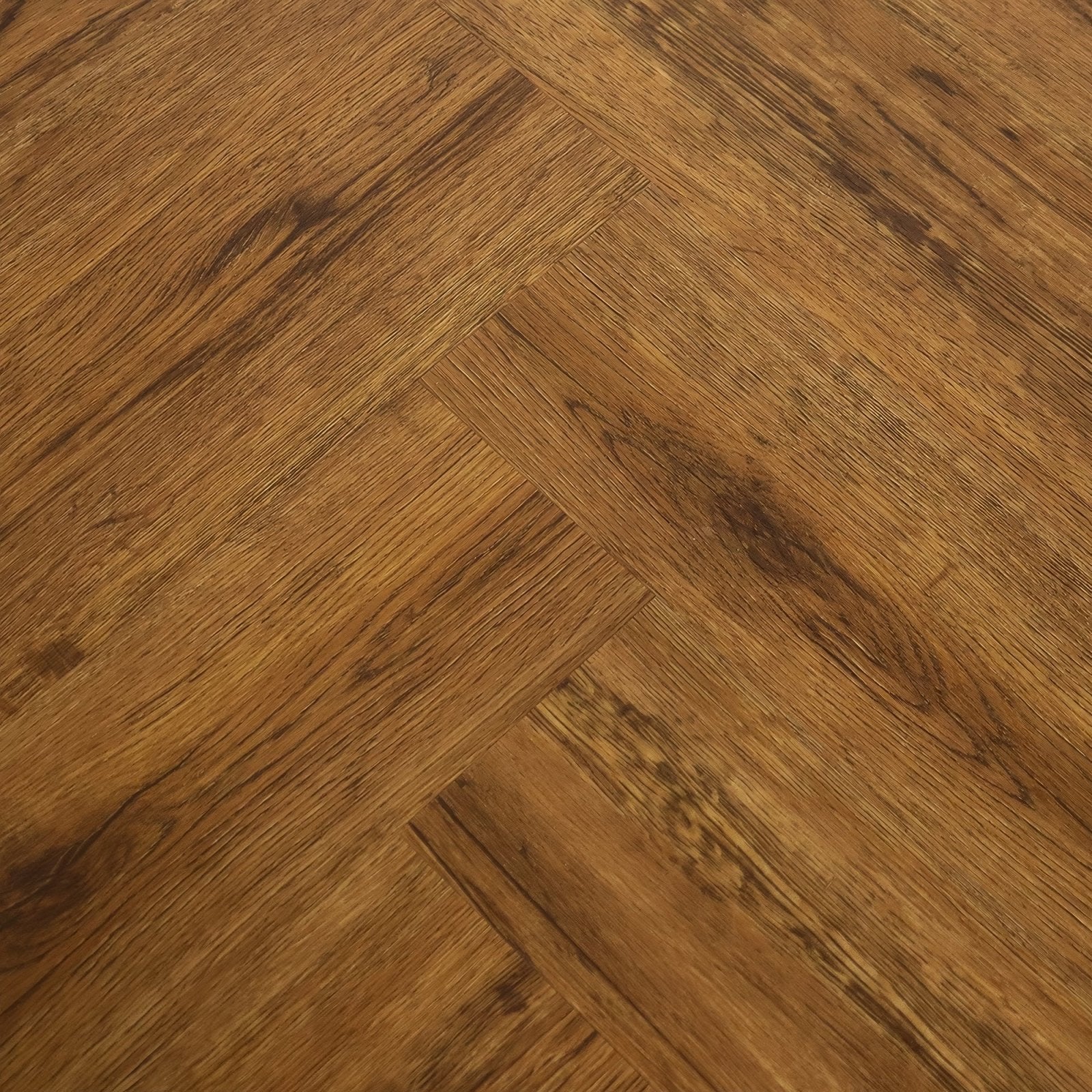 Warm brown hardwood flooring in a herringbone pattern featuring vine oak in the weymouth collection