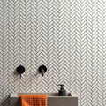 White Satin Chevron white satin chevron mosaic with a sink, black soap dispenser and orange towel