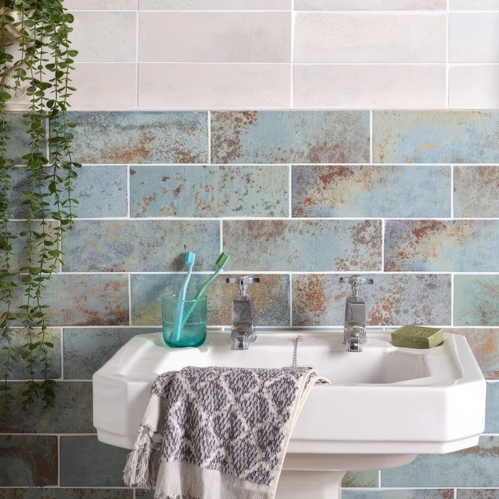White ceramic Wightwick Ceramic Azure sink with chrome faucets and patterned towel draped over the edge