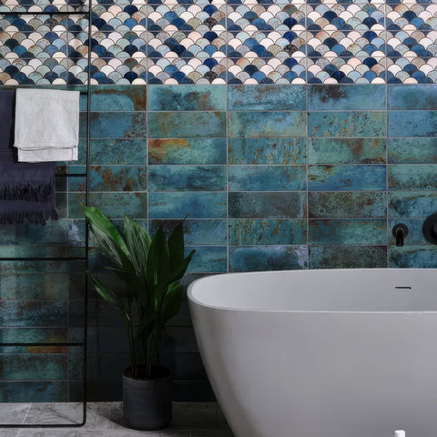 Wightwick ceramic emerald bathroom tiles feature teal and blue distressed scalloped and rectangular ceramic patterns above tub