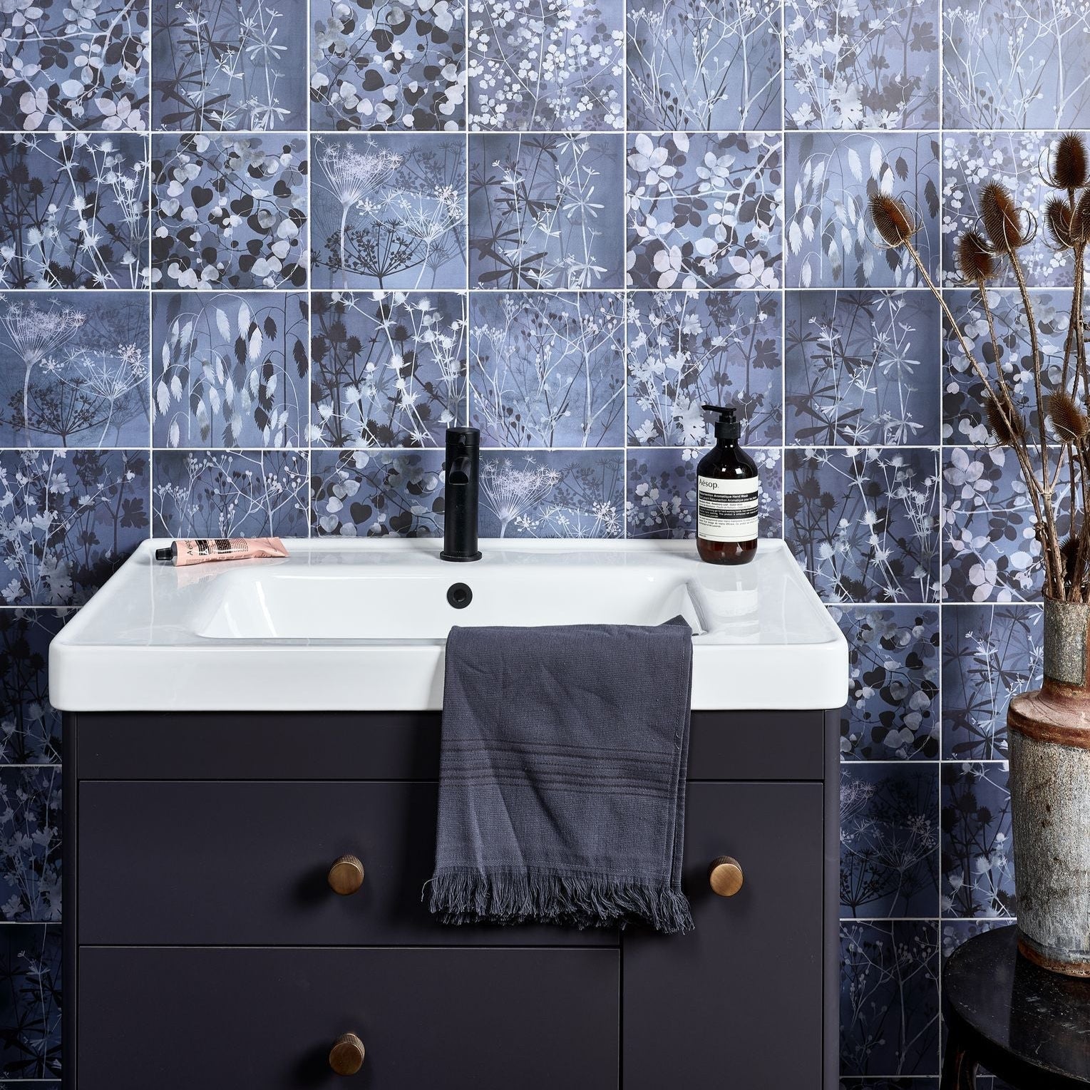 Wild Botanicals Porcelain Blue By Clarissa Hulse dark blue botanical porcelain tiles with a white sink and black tap