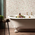 White clawfoot bathtub with gold fixtures against a floral wallpaper backdrop in wildflower rose 60x30cm design