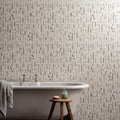 White wildflower violet freestanding bathtub with gold-toned faucets and gray towel draped over the side 60x30cm