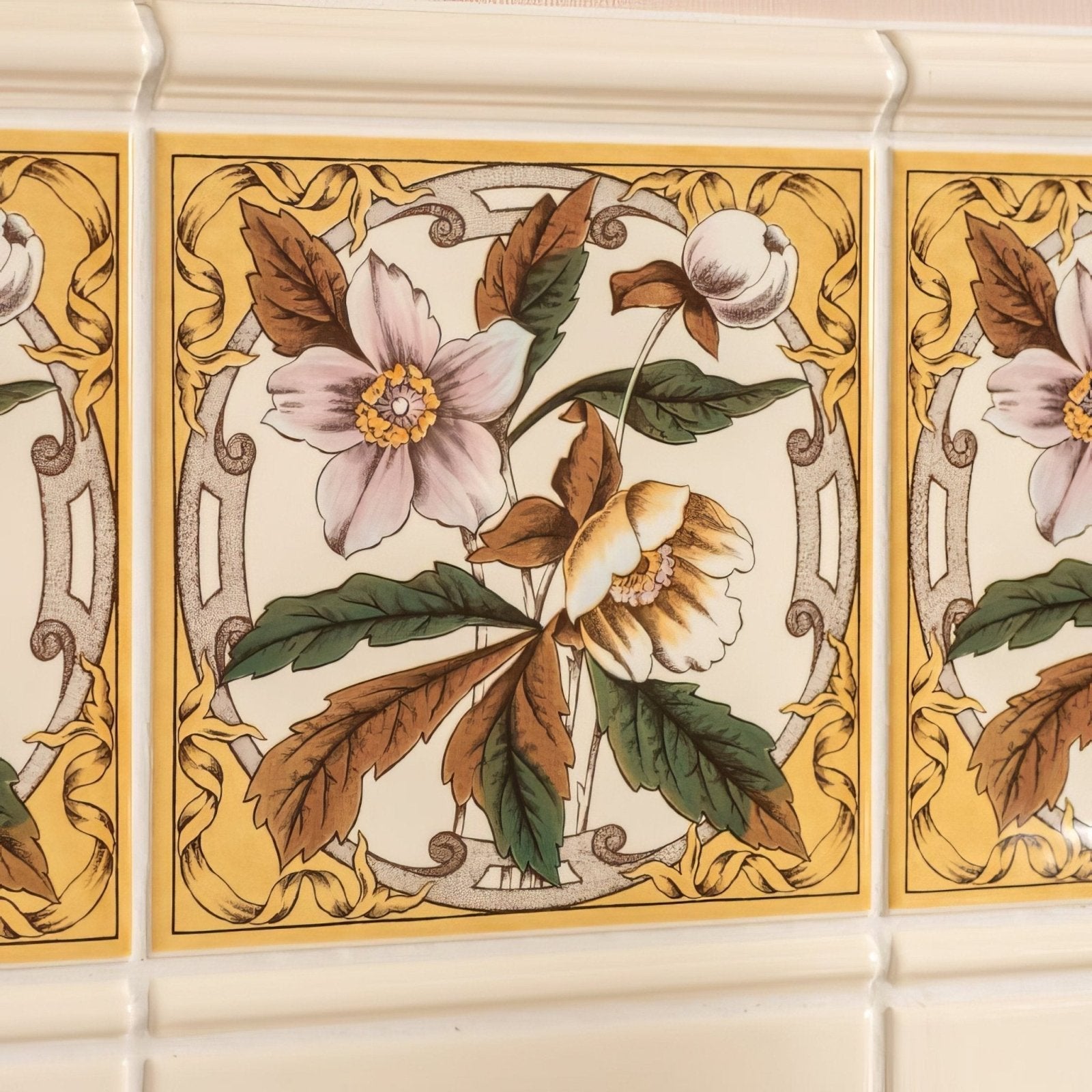 Beige ceramic windflower single tile on county white with ornate floral design in pink yellow green and gold scrollwork