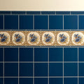 Windsor Blue Hogarth moulding ceramic tile strip with blue flower and bird motifs on cream background with gold detailing