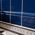Windsor blue skirting tile featuring deep blue glossy ceramic tiles with decorative border and white grout lines