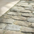 Weathered gray windsor sandstone cobble reclaimed and sawn with rough uneven surfaces and visible mortar joints