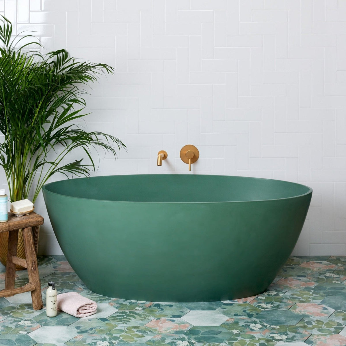 A sleek matte-finish emerald green freestanding porcelain bathtub woodland glade with a modern oval design