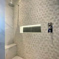 World Hexagon Tex White Mosaic white and grey hexagonal marble mosaic with a chrome showerhead