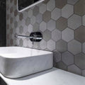 World Hexagon Texture Grey Mosaic grey hexagonal textured mosaic with a white marble vessel sink
