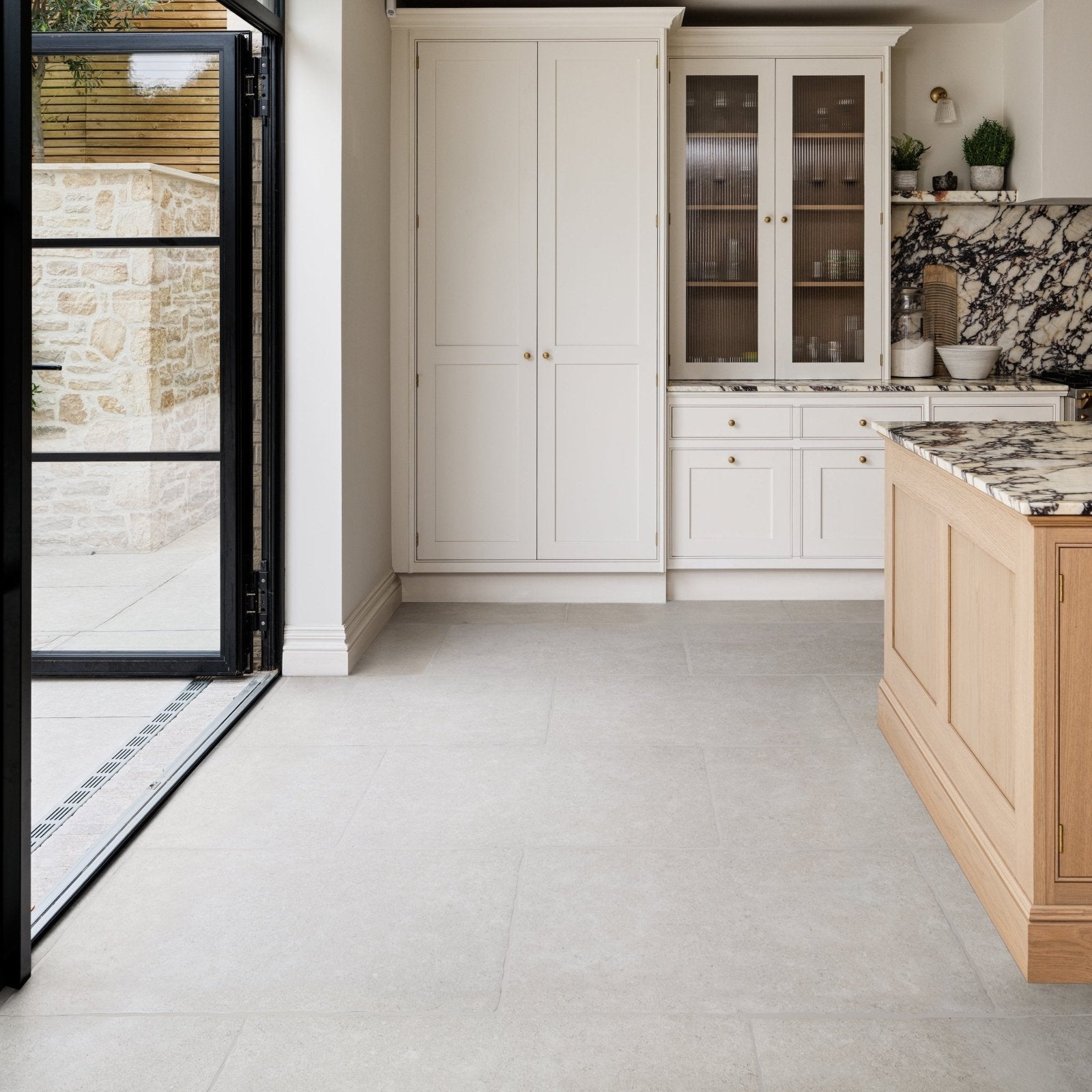 Modern kitchen with wychwood claire porcelain matt 60 x 90cm light gray floor tiles and white marble countertops