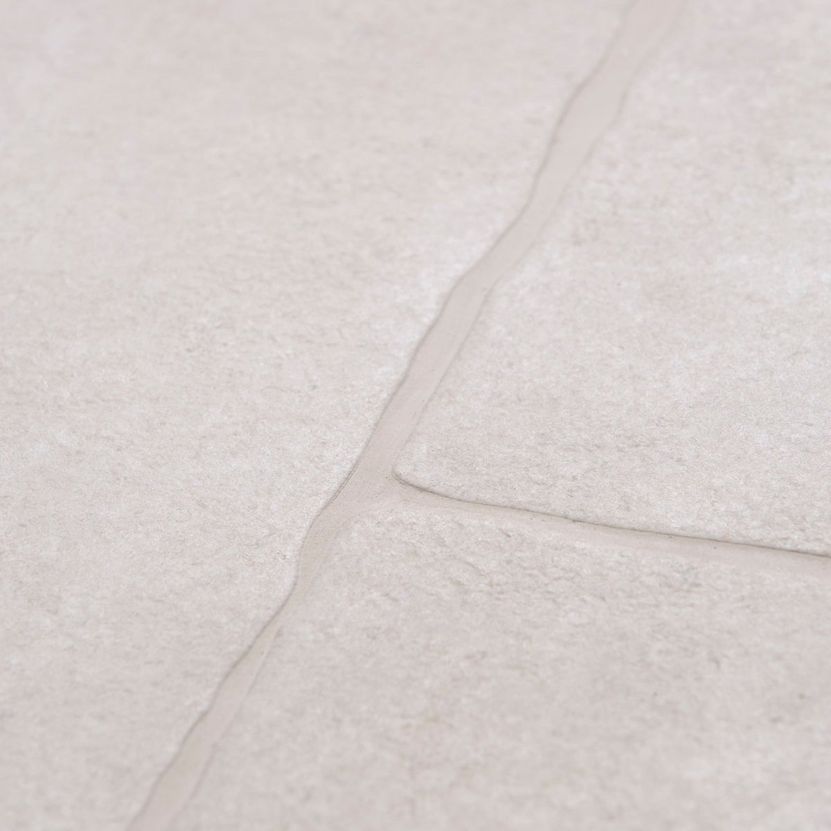 Beige textured stone tiles with subtle natural veining wychwood claire porcelain paving textured for outdoor use