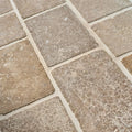Beige wychwood limestone tumbled and etched cobble stone tiles with a textured rustic finish and natural tone variations