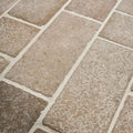 Beige rectangular wychwood limestone tumbled and etched cobble tiles with textured rustic surface and white grout lines