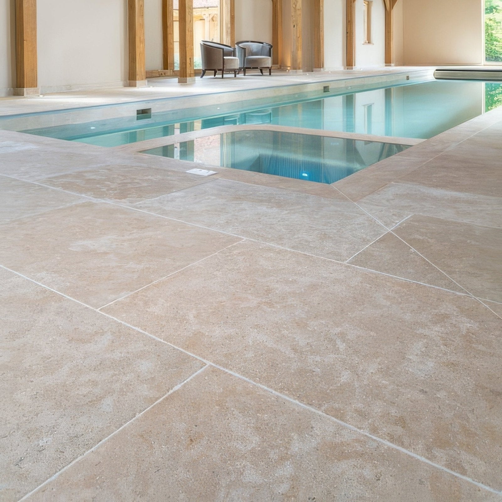 Beige wychwood limestone tumbled and etched finish stone tiles with textured natural finish in indoor pool area