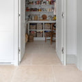Wychwood limestone tumbled finish floor tile in light beige with natural stone texture and visible grout lines