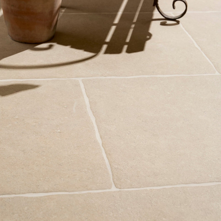 Beige wychwood porcelain paving textured stone tiles with subtle texture and white grout lines for outdoor use