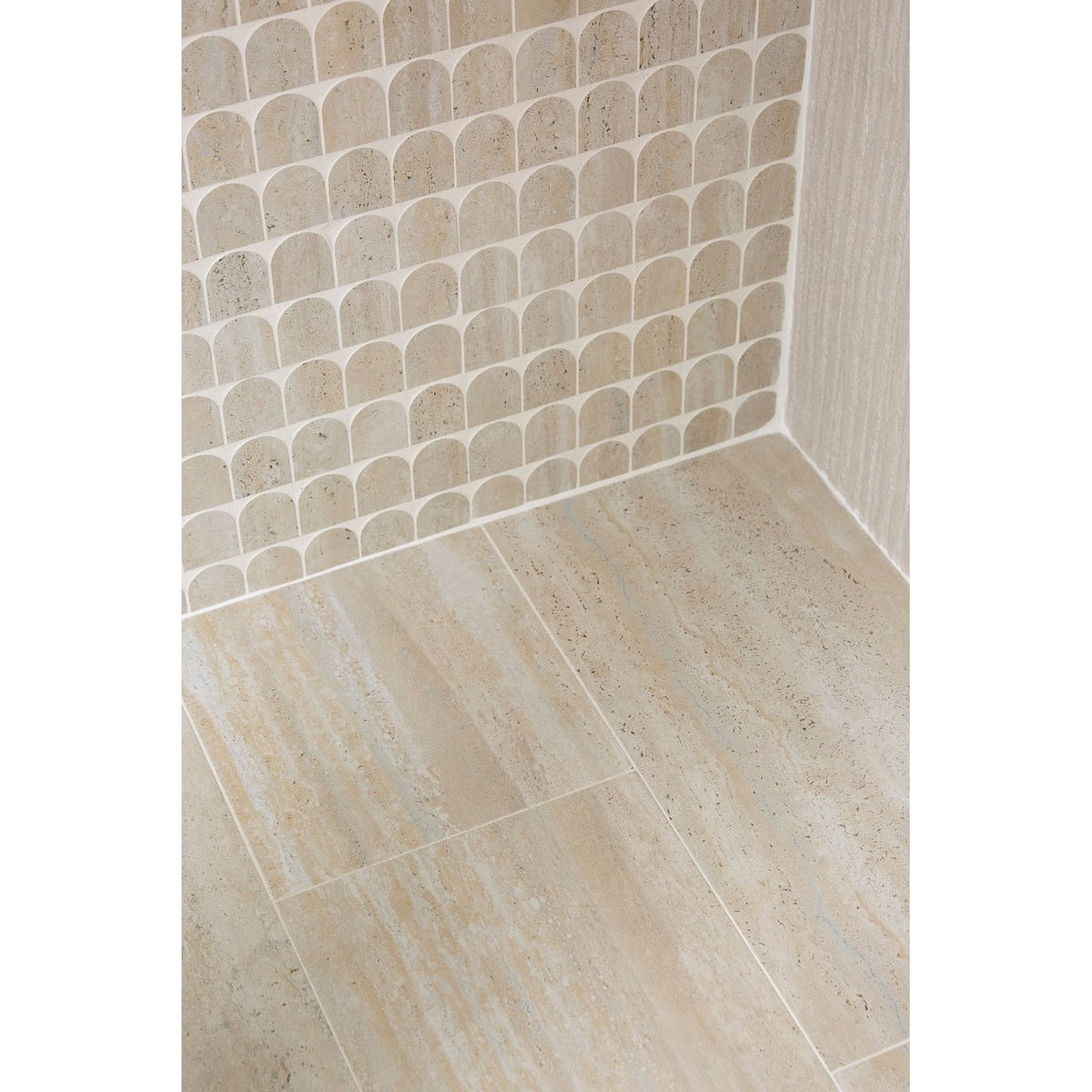 Beige-toned textured stone tiles with subtle veining in zahara porcelain arch mosaic design