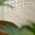 Beige zahara porcelain matt stone tiles with subtle veining and arched accent pieces for elegant flooring designs