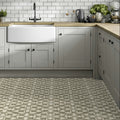 White farmhouse sink with black faucet set into light wood countertop featuring zayda sage matt vitrified ceramic tile