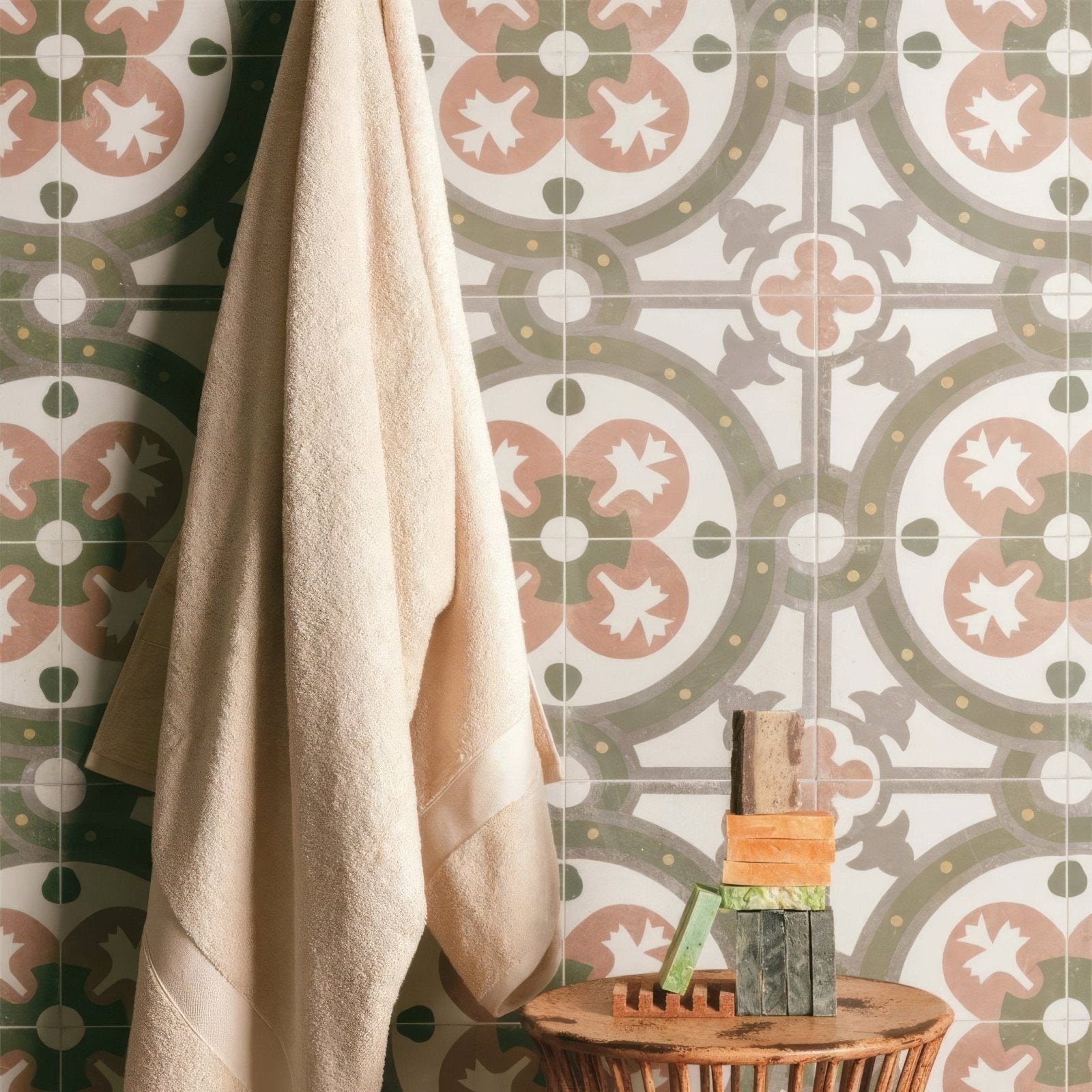 Beige textured towel hanging against zayda sage multi matt vitrified ceramic patterned tile wall 450x450mm