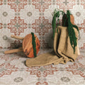 Wooden stool with round natural-toned wooden seat and two light-colored wooden legs for zayda terracotta matt vitrified ceramic 450x450mm
