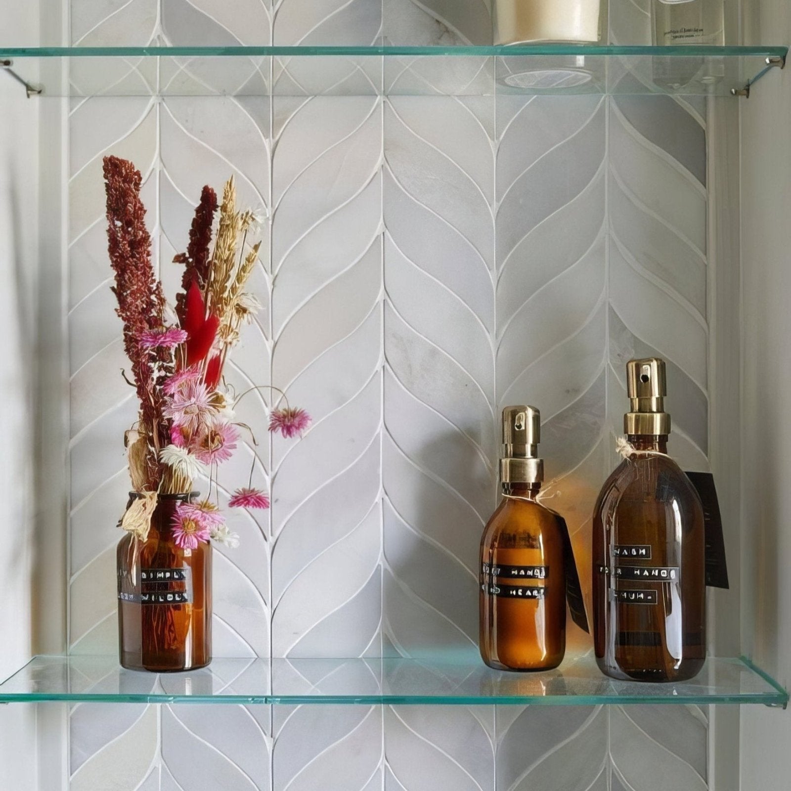 Zen Marble Leaf Mosaic white marble herringbone leaf mosaic with two amber spray bottles
