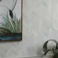 White marble tile with subtle veining arranged in a herringbone design for zen marble leaf mosaic pattern