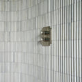 Zen Marble Reed Mosaic white marble reed mosaic with a silver dual-handle shower tap