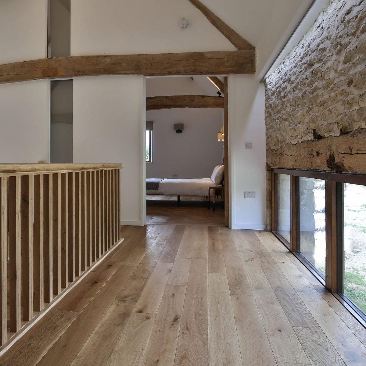 Alpine oak rustic brushed and oiled light-colored oak hardwood floor with visible wood grain and natural knots