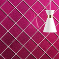 A sleek white andia constellation glass pendant lamp with gold accent hangs against a magenta glitter wall