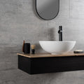 Atrium Marte Grafito Tiles grey concrete-effect tiles with a white bowl sink on a wooden countertop