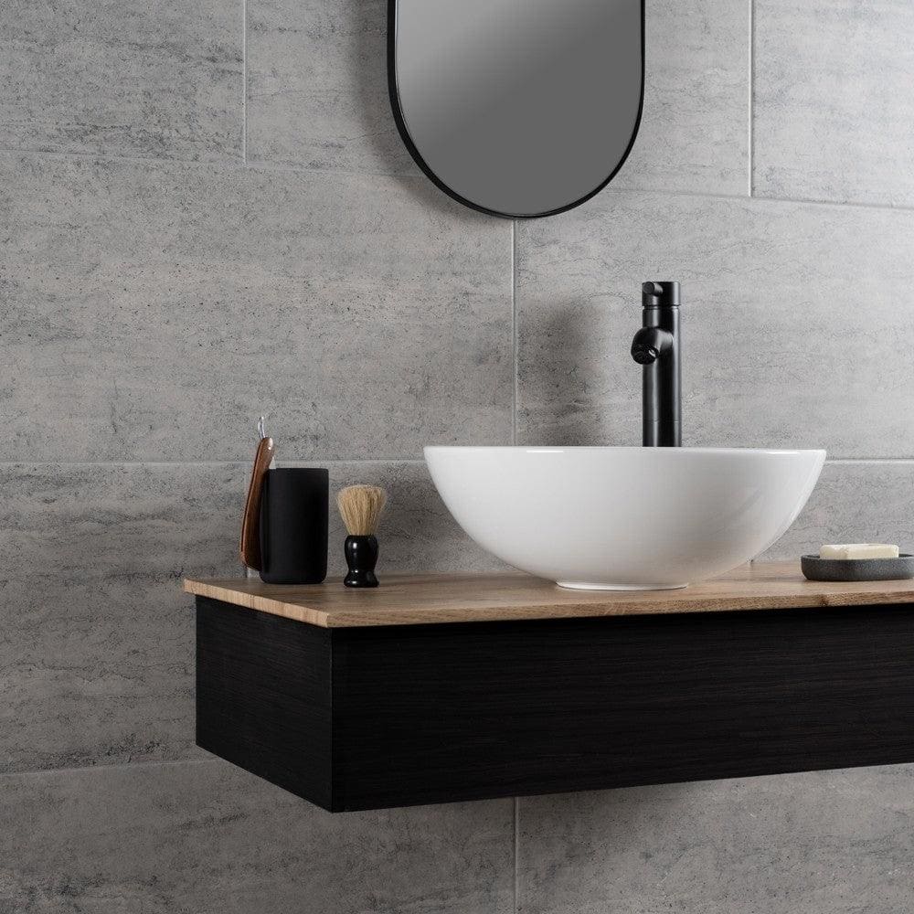 Atrium Marte Grafito Tiles grey concrete-effect tiles with a white bowl sink on a wooden countertop