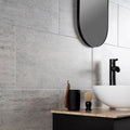 Atrium Marte Grafito Tiles grey concrete-effect tiles with a black shaving brush holder