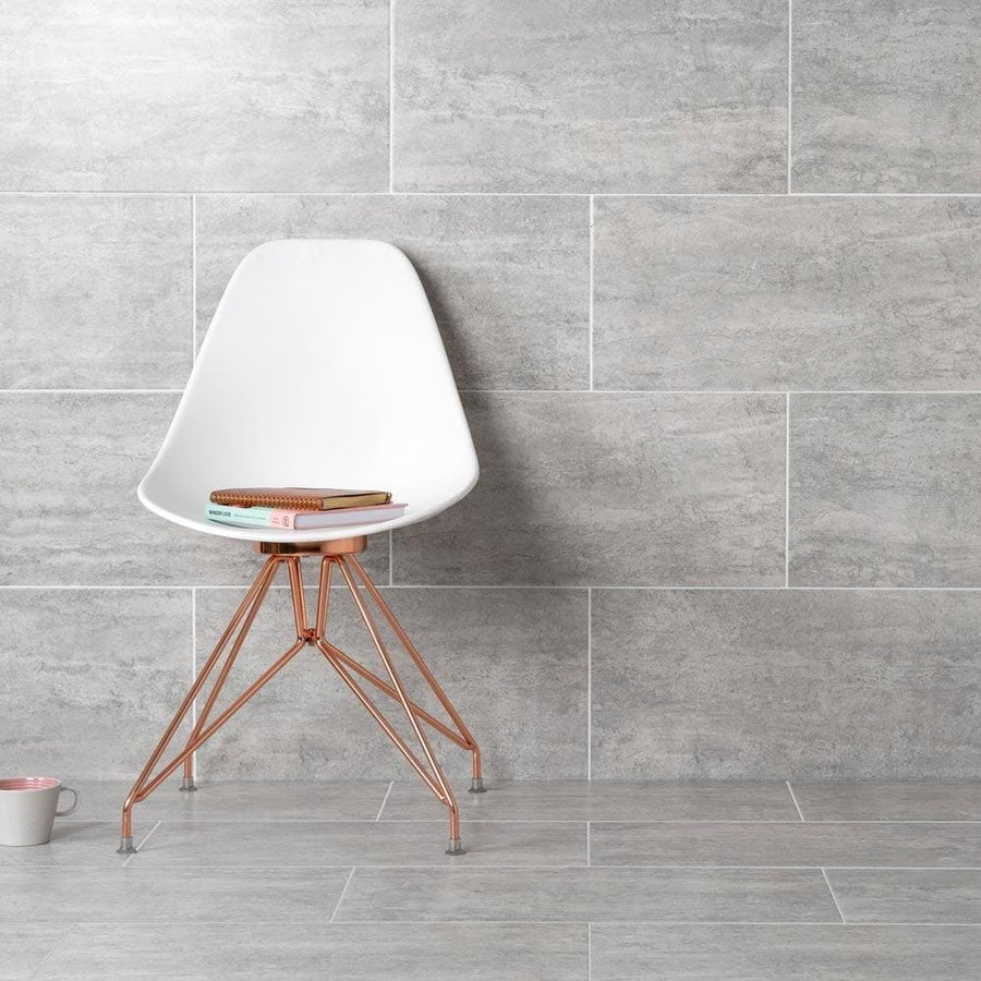Atrium Marte Gris Tiles grey stone-effect floor tiles with a white moulded chair