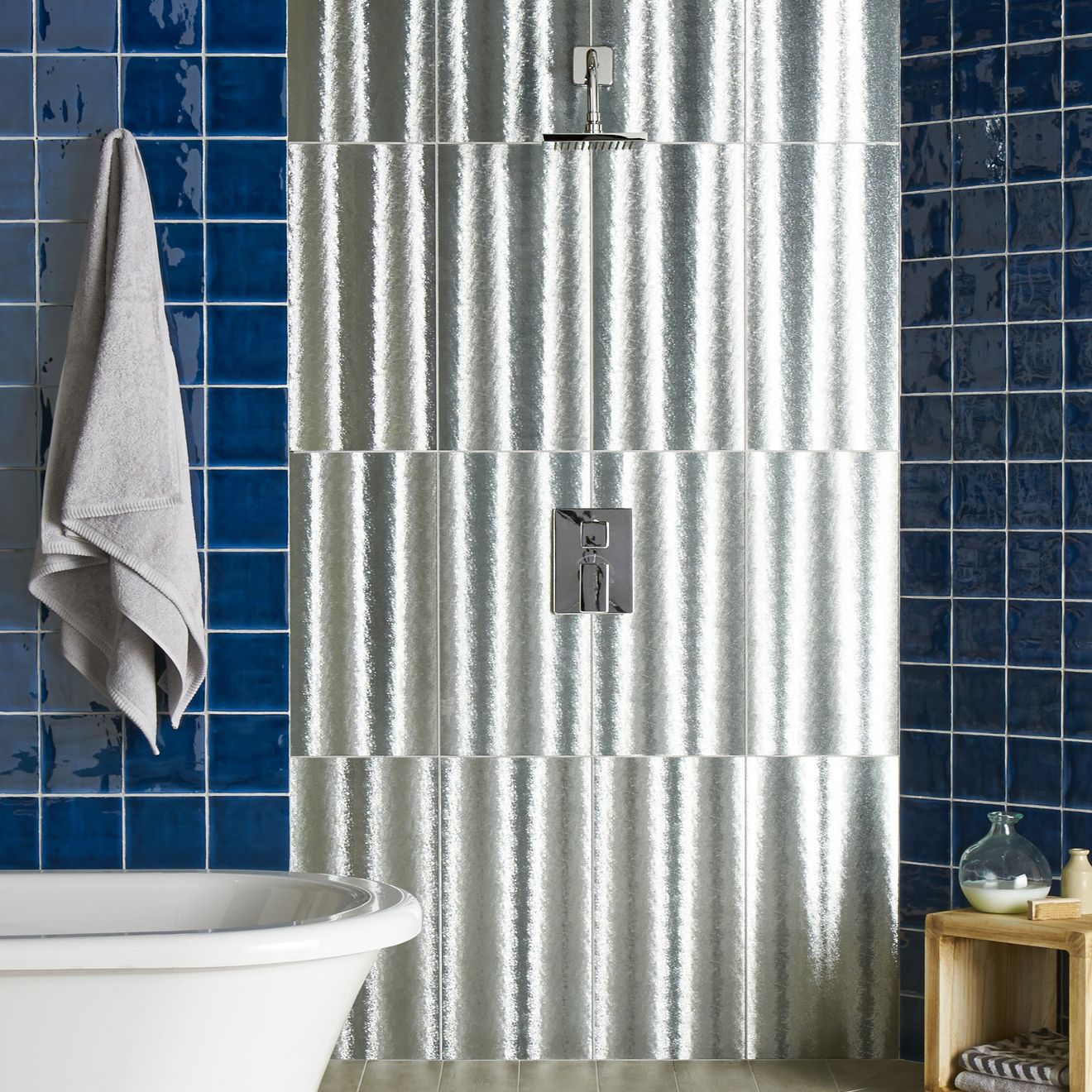 Silver corrugated metal shower wall panel with textured reflective surface from bastille field tile collection