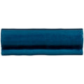 A glossy teal ceramic bastille torus moulding tile with a slightly irregular wavy edge for decorative use